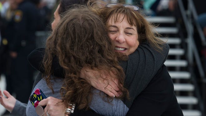 Lynn BeBeau, of Ashland, Wisc. hugs Sarah Glaze, of Cameraon, Wisc., during the National Law Enforcement Officers Memorial Fund 30th annual Candlelight Vigil.