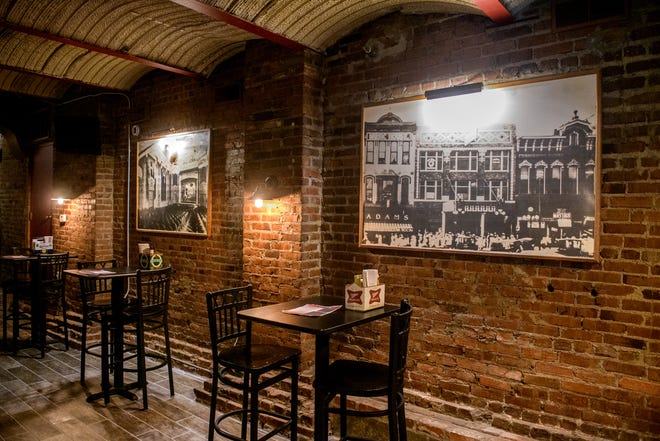 Photos of old Peoria hang on the original brick walls of Richard's Under Main in downtown Peoria.