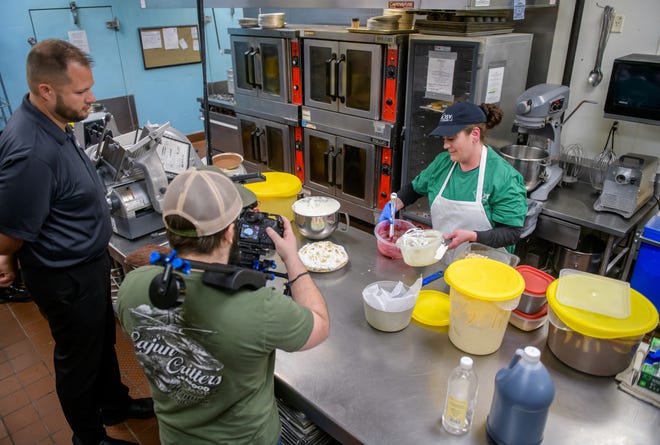 Leslie Thies, right, prepares ingredients for a pie as videographer Michael Dick records a freshly-made one during filming of an episode of :"America's Best Restaurants" on Wednesday, March 13, 2024 in Goodfield.
