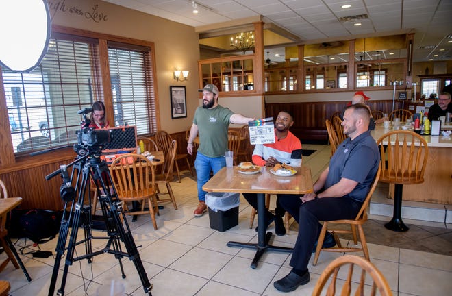 Videographer Michael Dick snaps the clacker for an episode of the online show "America's Best Restaurants" at the popular Busy Corner restaurant Wednesday, March 13, 2024 in Goodfield.
