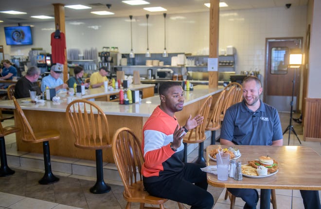 "America's Best Restaurants" host J Russell, left, chats with Derek Vollmer, owner of the Busy Corner, a local landmark restaurant at 302 Eureka Street in Goodfield, while filming an episode of the web show on Wednesday, March 13, 2024 in Goodfield.