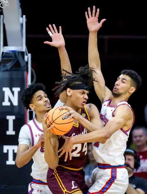 Bradley's Darius Hannah, left, and Malevy Leons pressure Loyola Chicago's Miles Rubin in the first half of their first-round NIT basketball game Wednesday, March 20, 2024 at Carver Arena.