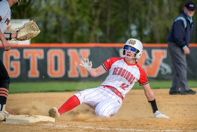 Metamora's Addy Wooden slides into third base as the Redbirds battle Washington in a Mid-Illini Conference softball game Thursday April 25, 2024 at Jan Smith Field in Washington. The Redbirds defeated the Panthers 11-2.