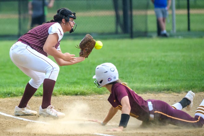 Dunlap third baseman Justice Krus fields the throw as Dunlap baserunner Mersadess Sassman slides in safely during their Mid-Illini Conference softball game Thursday, May 2, 2024 at Dunlap High School. The game was rained out in the sixth inning with the score tied at two apiece.