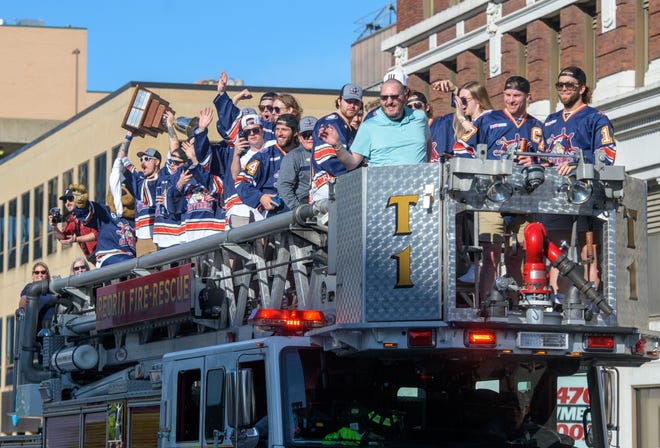 The Peoria Rivermen greet their fans from atop a Peoria Fire Department ladder truck on their way to a public celebration for the SPHL hockey championship Friday, May 3, 2024 at the Peoria Civic Center.