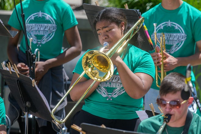 Sunlight glints off Richwoods senior Kirsten Polk's trombone as she performs with the high school jazz band during the 38th Gerald M. Brookhart Arts in Education Series Spring Celebration on Wednesday, April 30, 2024 at the Peoria County Courthouse Plaza in downtown Peoria.
